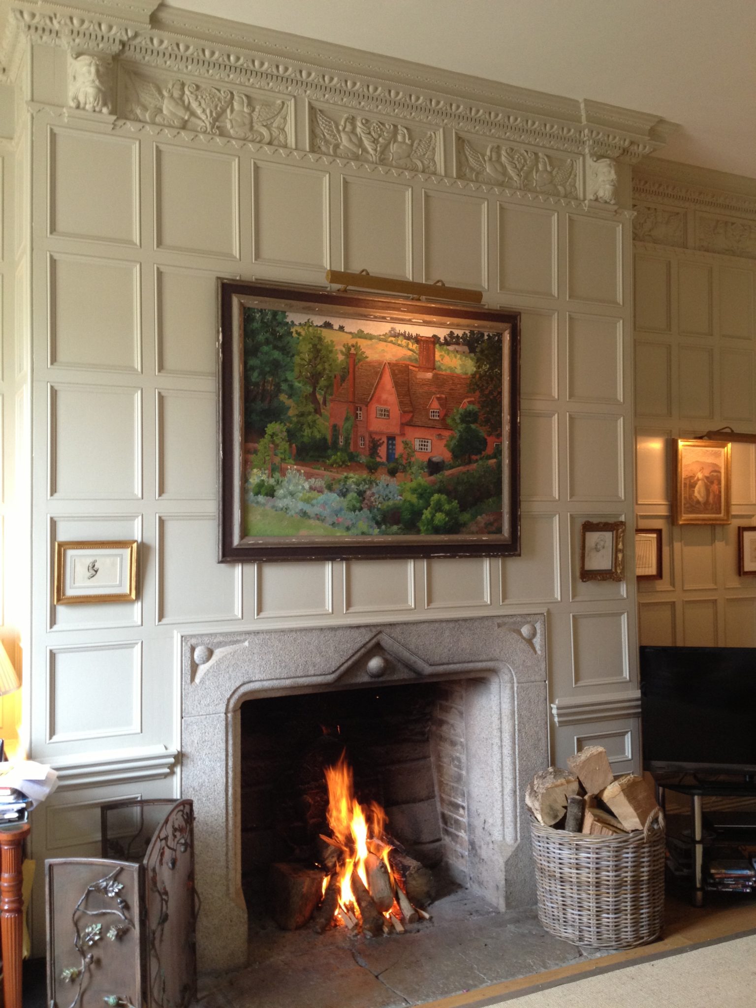 A snug with Jacobean panelling some rescued from the original house and restored. I love the fact that it has been painted to work with the rest of the house's interior