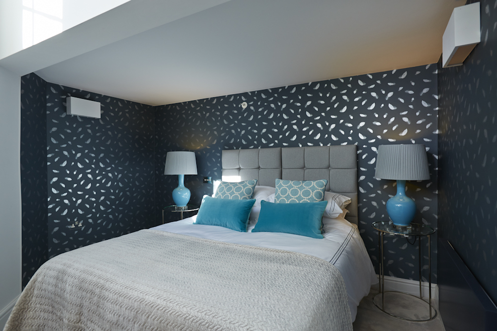 Guest bedroom with wallpaper that sparkles in the light