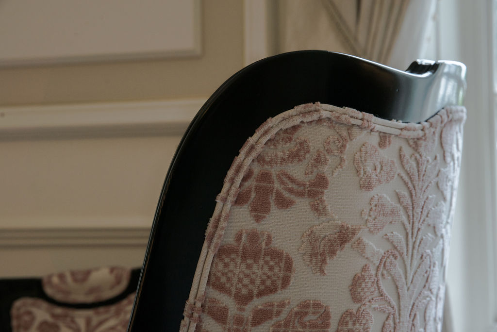 Georgian library with wood panelling and red tapestry-pattern upholstered sofa.