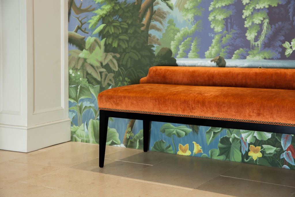 georgian-hallway-velvet-bench-scenic-wallpaper Ochre velvet bench against scenic mural wallpaper in a classical interior hallway.